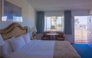 bed and table with chairs with views of ocean